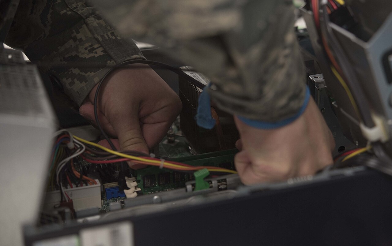 A technician replacing computer hardware
