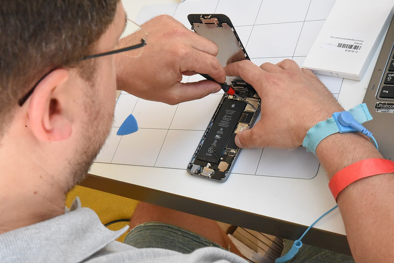 A technician repairing a smartphone